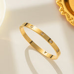 18K gold plated flush crystal flat band bangle by Biya Accessoires.