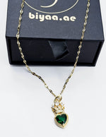 Waterproof vintage royal heart gold jewelry on silk background.