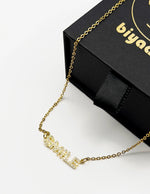 Waterproof gold smile word pendant on silk Dubai.