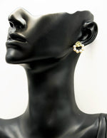 Elegant gold flower stud earrings with a faux pearl semi-circle.