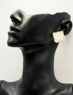 Biya Accessoires gold twisted square stud earrings with iridescent crackle stone.