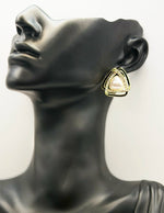 Triangular earring on a mannequin ear
