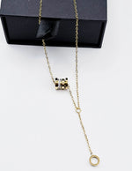Biya Accessoires 18K gold plated cylinder lariat necklace with pavé crystals.