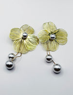 Close up of imitation jewelry uae statement dangles featuring laser-cut petals.