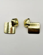 Close up of imitation jewelry uae statement studs featuring high-shine hardware.
