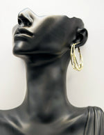 Close up of imitation jewelry uae statement hoops featuring multi-layered crystal bands.