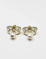 Biya Accessoires artificial jewellery online dubai white enamel ribbon and pearl drop earrings.
