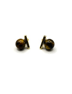 Biya Accessoires geometric gold bar and brown pearl stud earrings.