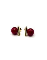 Biya Accessoires geometric gold bar and red pearl stud earrings.