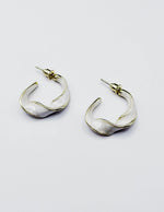 Close up of premium hypoallergenic imitation jewelry featuring a pearlescent cream design.