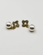 Biya Accessoires gold crystal knot and pearl drop earrings.