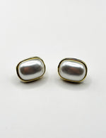 Minimalist large faux pearl earrings with a sleek gold border.