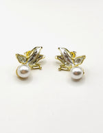 Everyday luxury fashion jewelry gold tone pearl studs by Biya Accessoires Dubai.