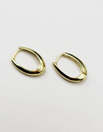 Biya Accessoires high-polish gold oval huggie hoop earrings.