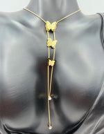 Gold butterfly necklace on a mannequin
