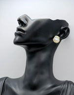 Minimalist abstract gold earrings with a luminous faux pearl.