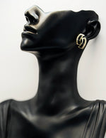 Elegant sparkling abstract earrings with black enamel details.