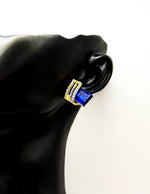 Biya Accessoires emerald blue and gold geometric stud earrings with crystal pavé.