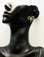 Everyday luxury fashion jewelry gold tone bow studs by Biya Accessoires Dubai.