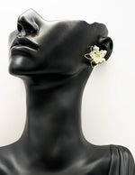 Best imitation jewellery brands in uae gold wire floral studs with faceted clear beads.