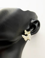 Close up of premium hypoallergenic imitation jewelry featuring an enamel and crystal insect design.