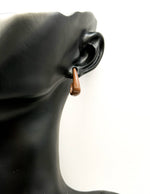 Everyday luxury fashion jewelry glossy neutral studs by Biya Accessoires Dubai.