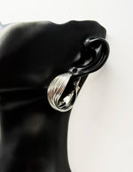 Biya Accessoires silver multi strand twisted hoop earrings.