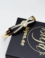 18K gold plated Roman numeral solitaire split band bangle by Biya Accessoires.