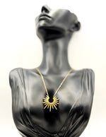 Waterproof gold sunburst spike pendant necklace in green gift box by Biya Accessoires.