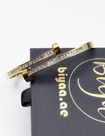 Hypoallergenic gold plated pavé channel bangle architectural jewelry.
