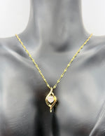 Minimalist 18K gold plated crystal pendant on textured gold chain.