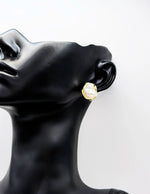 Close-up of premium hypoallergenic imitation jewelry featuring a freeform gold design.