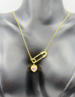 Model wearing an edgy pink heart gold necklace in the UAE market.