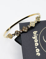 Hypoallergenic non-tarnish high polish gold rigid floral bangle UAE.