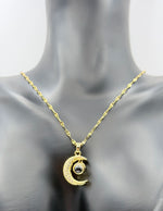 Modern luxury gold and pavé crystal moon necklace with projection stone.