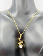 Modern luxury gold and pavé crystal spiral statement necklace.