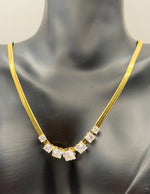 Waterproof gold snake chain necklace with graduated cubic zirconia.