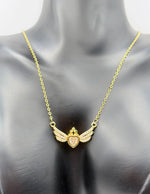 Modern luxury gold and pavé crystal heart statement necklace in gift box.
