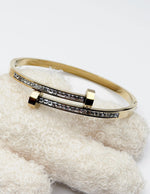 Hypoallergenic gold plated pavé channel bangle architectural jewelry.