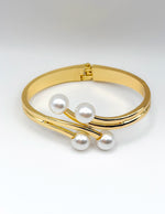 Non-tarnish elegant four pearl statement bangle for women Dubai luxury fashion.