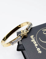 Hypoallergenic non-tarnish high polish gold rigid channel set bangle UAE.