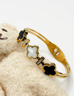 18K gold plated quatrefoil station split band bangle by Biya Accessoires.