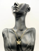 Waterproof gold butterfly necklace with rainbow marquise stones on white silk.