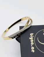 Hypoallergenic non-tarnish high polish gold twisted bangle UAE.