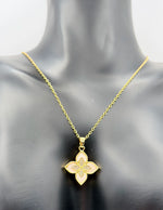 Modern luxury gold and pavé crystal quatrefoil statement necklace.