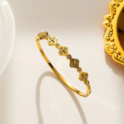 18K gold plated crystal clover station bangle by Biya Accessoires.