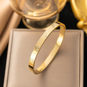 18K gold plated engraved heart and flush crystal bangle by Biya Accessoires.