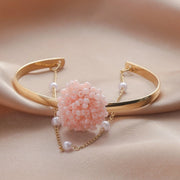 Hypoallergenic gold plated open bracelet with pink beaded centerpiece United Arab Emirates.