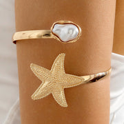 Waterproof 18K gold upper arm cuff with starfish and baroque pearl Biya Accessoires UAE.