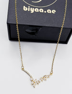 18K gold plated Seraphina asymmetrical crystal wing necklace by Biya Accessoires.